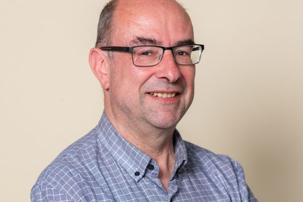 A man with glasses looking at the camera