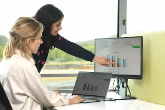 two EnergyVille colleagues discussing work